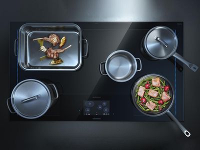 Overhead view of multiple pans cooking on induction hob