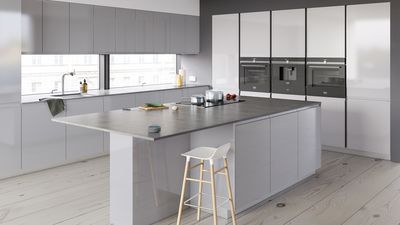 Spacious silver kitchen with large kitchen island in centre