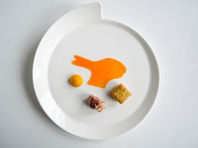 three mini desserts on a plate with rabbit art 