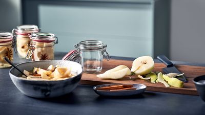Siemens: bowl with fruits next to pear on cutting board in kitchen