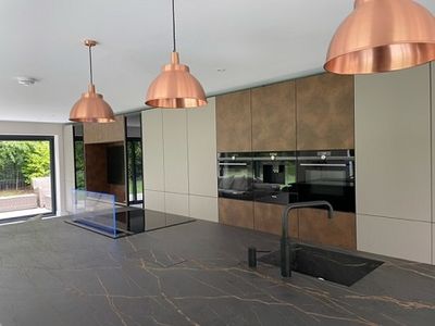 Rustic kitchen island designed using natural materials and studioLine Downdraft venting