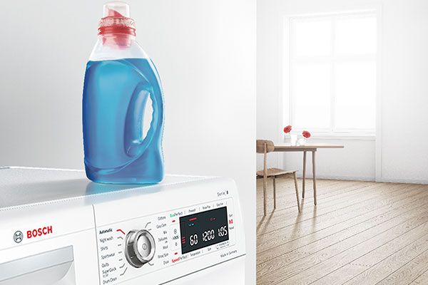 A Bosch washing machine with blue liquid detergent