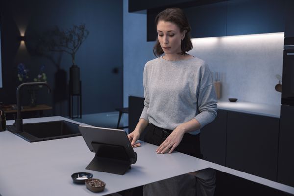 Woman using smart kitchen dock