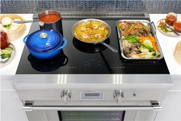induction range top view with pots and pans