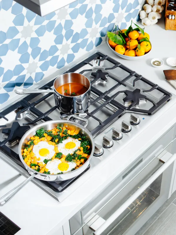 Thermador high-end gas cooktop with food overhead shot