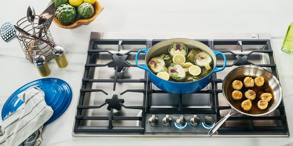 blue enameled cast iron pot on gas cooktop