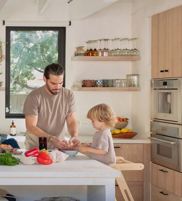Man with son prepping breakfast – built-in coffee machine and speed oven Thermador.com photo