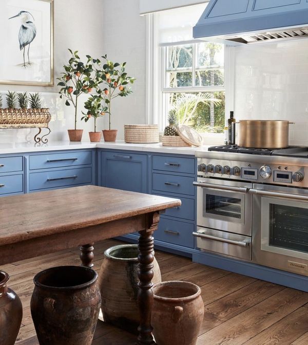 blue kitchen with antique wood table and dark 