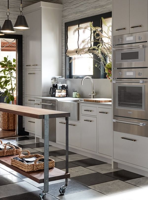 Narrow island with metal legs & wood top in Thermador kitchen
