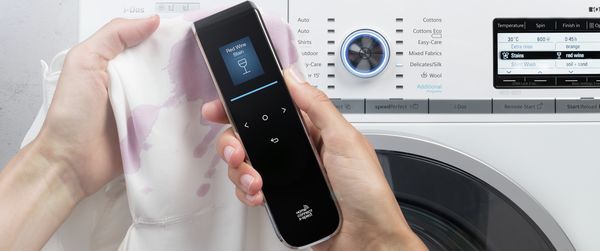 A woman scanning a piece of clothing with X-Spect