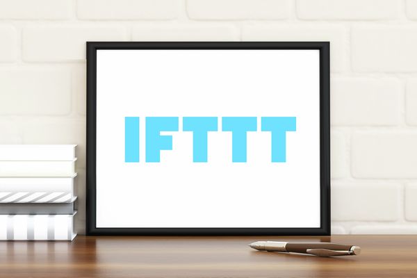 IFTTT logo in a photo frame in front of a wall