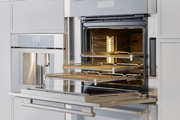 Thermador oven open with its telescopic racks pulled out