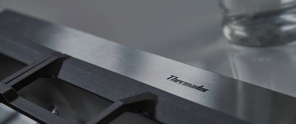 Thermador gas cooktop closeup shot of logo