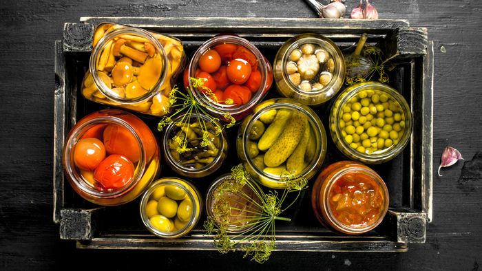 Overhead view of food items in jars sat in tray