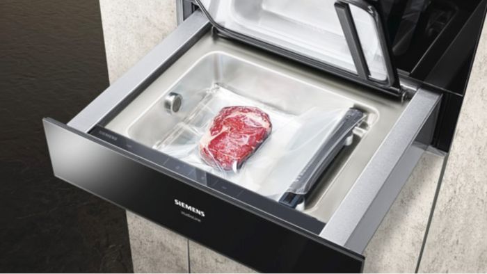 Piece of meat being sealed in vacuum drawer