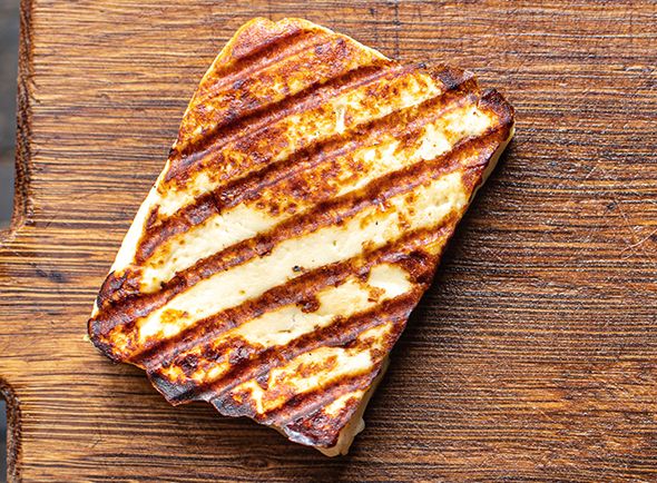 Pan-fried Halloumi on a wooden chopping board