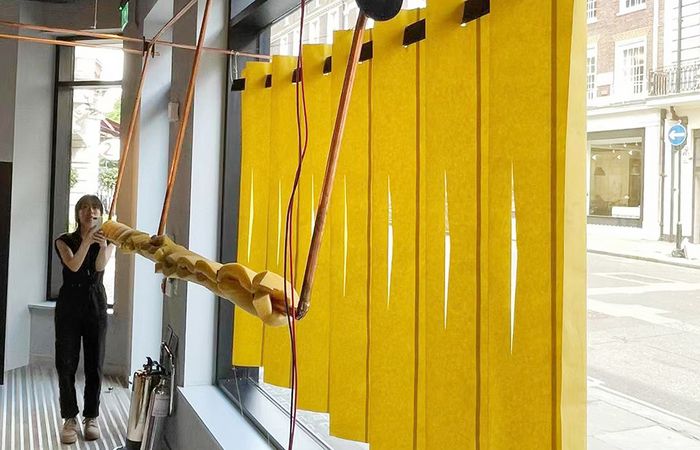 Creative workspace with hanging kitchen rolls, demonstrating an artistic use of space.