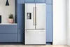 Bosch Stainless steel French door refrigerator in a modern kitchen with blue cabinets.