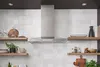 Bosch stainless steel kitchen hood mounted on a white tiled wall with wooden shelves.