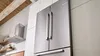 Bosch Stainless Steel Refrigerator angled shot built-in kitchen with white cabinets