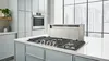 Bosch Stainless Steel Gas Cooktop and Downdraft Ventilation in white kitchen