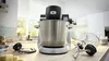 Bosch kitchen stand mixer and food processor in stainless steel with control knobs.
