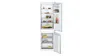 Open white refrigerator with various food items on shelves, including fruits, jars, and drinks.