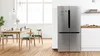 Three stainless steel Bosch kitchen appliances: a fridge-freezer combo, French door fridge, and tall freezer.