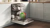Three dishwashers displayed together: a compact black model, a silver dishwasher, and a white one.