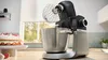 Robot pâtissier et robot culinaire Bosch en acier inoxydable avec boutons de commande.