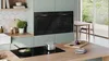 Bosch black built-in oven and induction cooktop with touch controls and digital display.