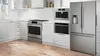 Modern kitchen with Bosch stainless steel appliances including oven, microwave, and fridge.