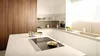 Modern kitchen with Bosch induction cooktop, wooden cabinets, and under-cabinet lighting.