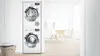 Stacked Bosch washer and dryer in a modern laundry room with natural light.