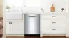 A Bosch sleek stainless steel dishwasher integrated into a modern white kitchen design.