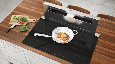 Bosch induction hobs cooking food on a pan.