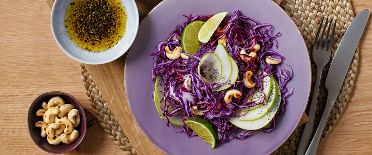 An appetizing salad of freshly shredded and sliced vegetables and cashews.