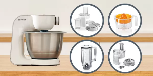 Silver Bosch food processor with chopped vegetables inside sits on a kitchen counter