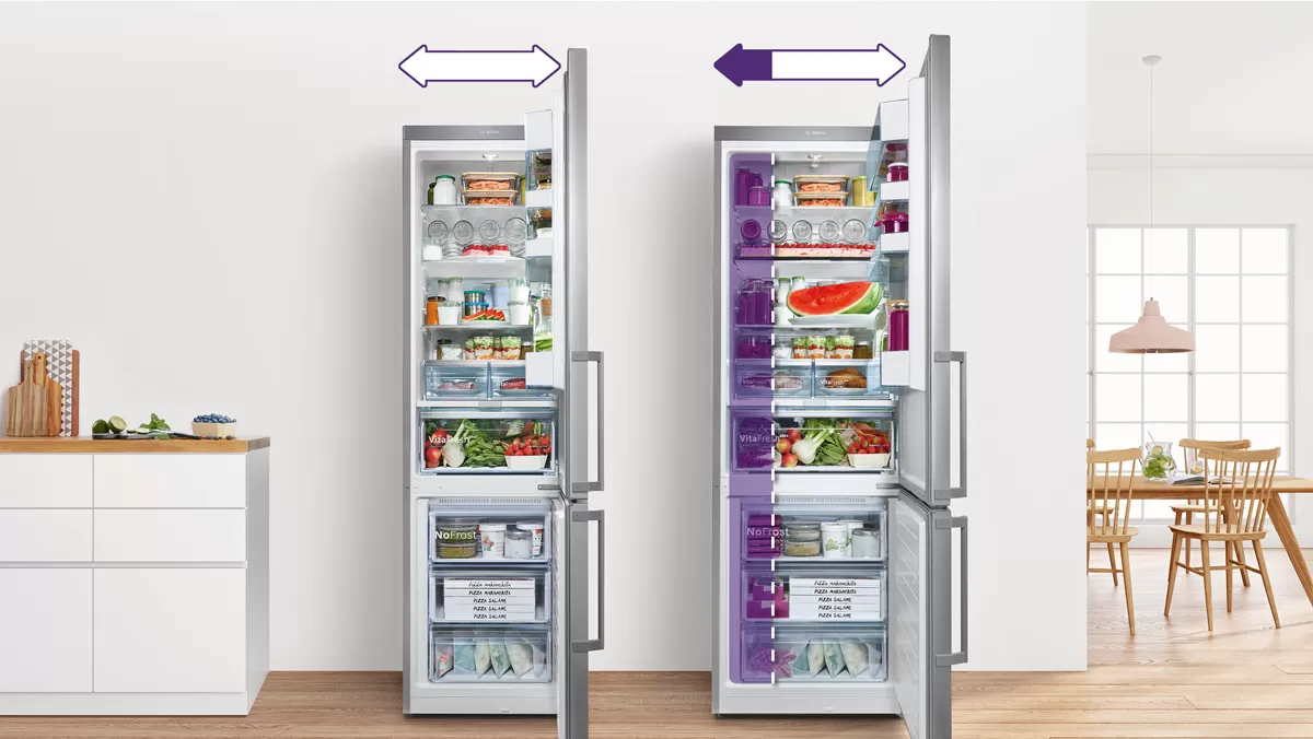 A freestanding fridge and a built-in fridge in modern kitchen with open doors.