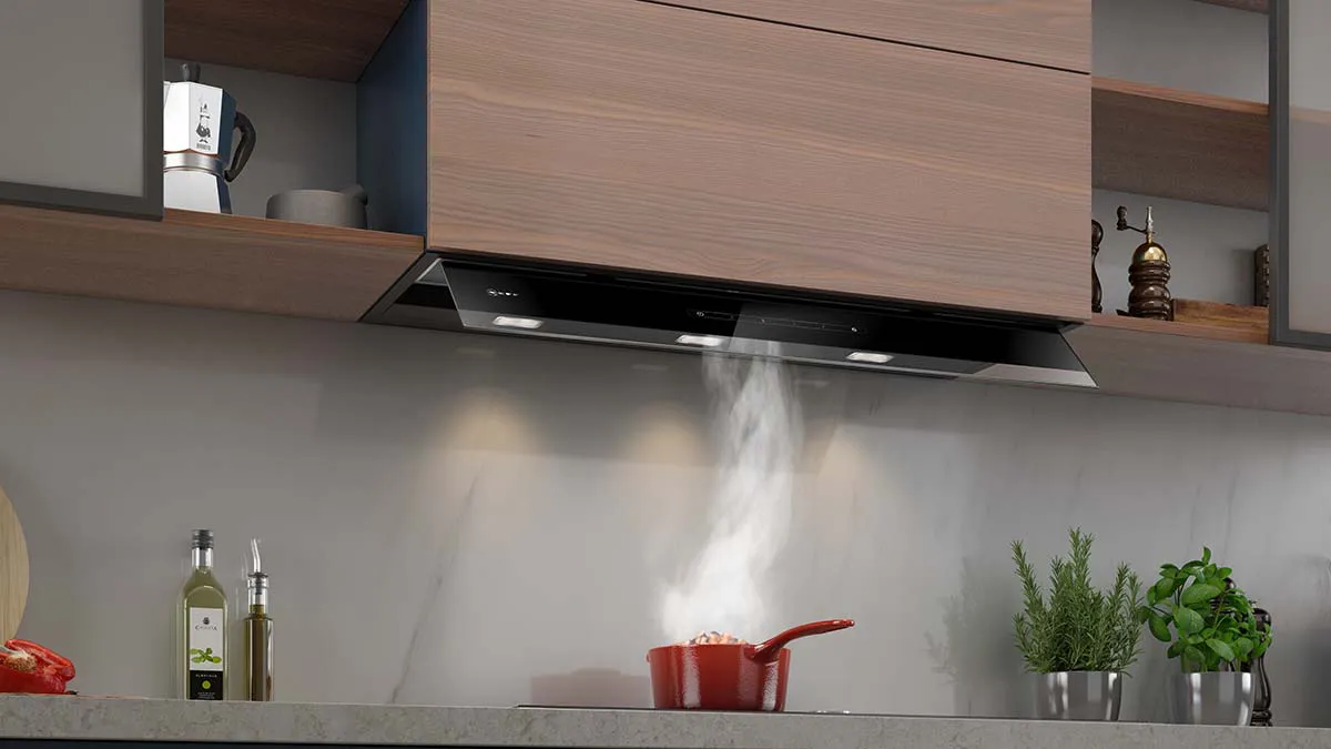 Modern kitchen with wooden cabinets, stainless steel appliances, and cooking utensils on the counter.