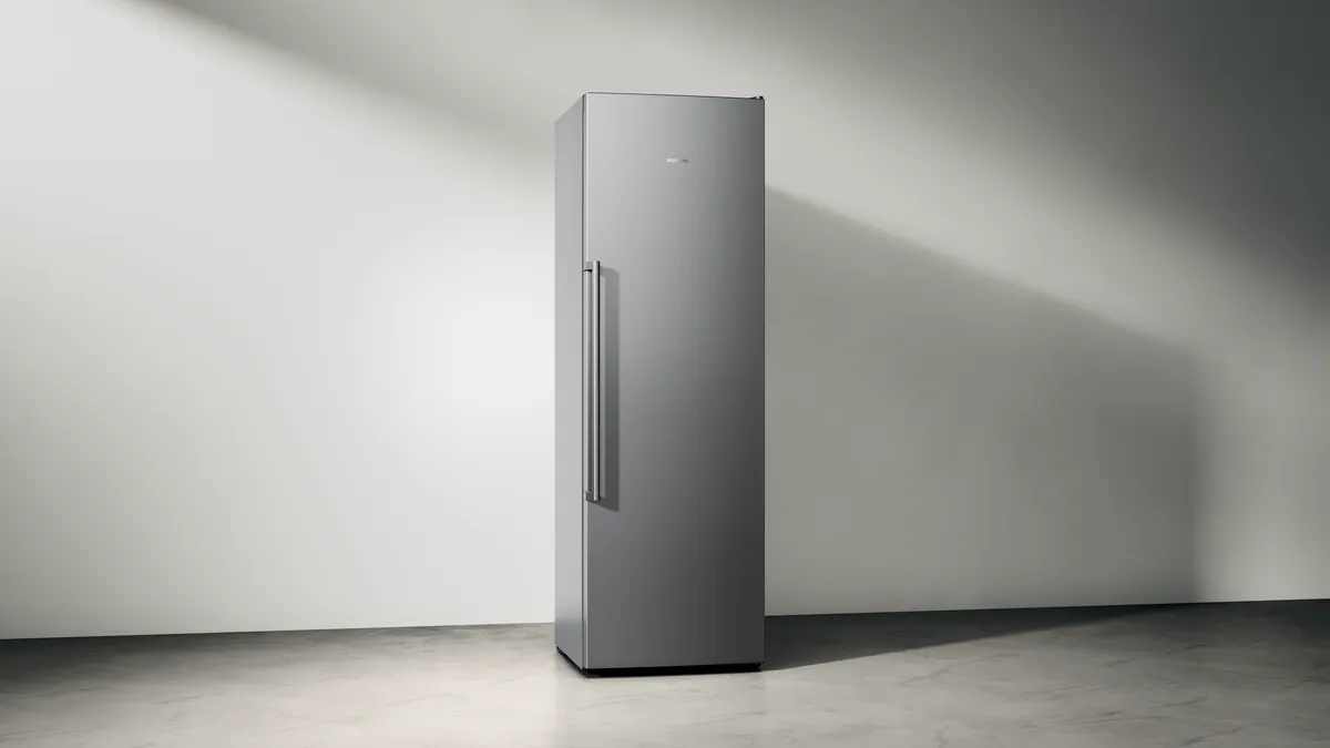 Sleek, modern refrigerator in a minimalist interior setting.