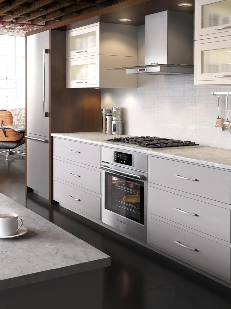 Modern kitchen featuring sleek stainless steel appliances, marble countertops, and contemporary cabinetry, with natural light illuminating the space.