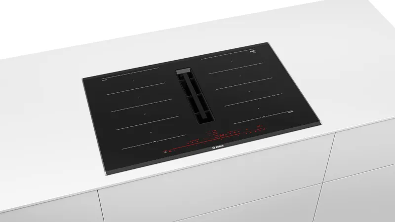 A sleek black induction hob with red digital controls is set into a white countertop. It has a modern, minimalist design with clean lines.