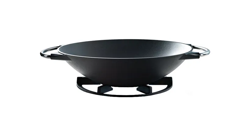 A black metal wok with handles rests on a matching stove rack, set against a white background. The sleek design conveys a modern, minimalist style.