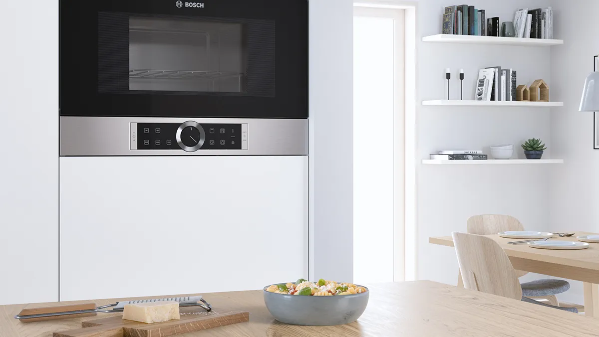 Built-in Bosch microwave with stainless steel finish and a user-friendly metal ring control, blending seamlessly.