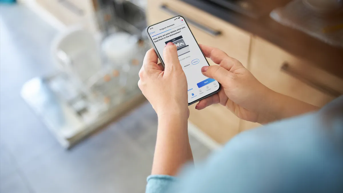 Person using the home connect app on a smartphone