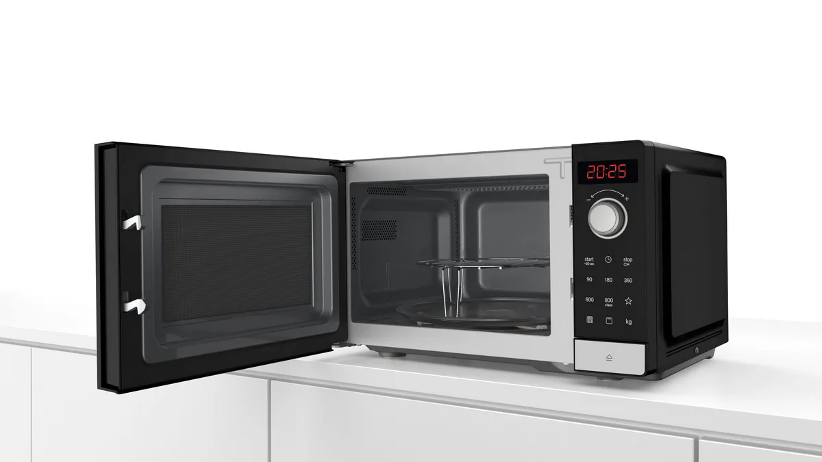 Microwave with grill and automatic settings, offering convenience with special defrost programmes for various food types.