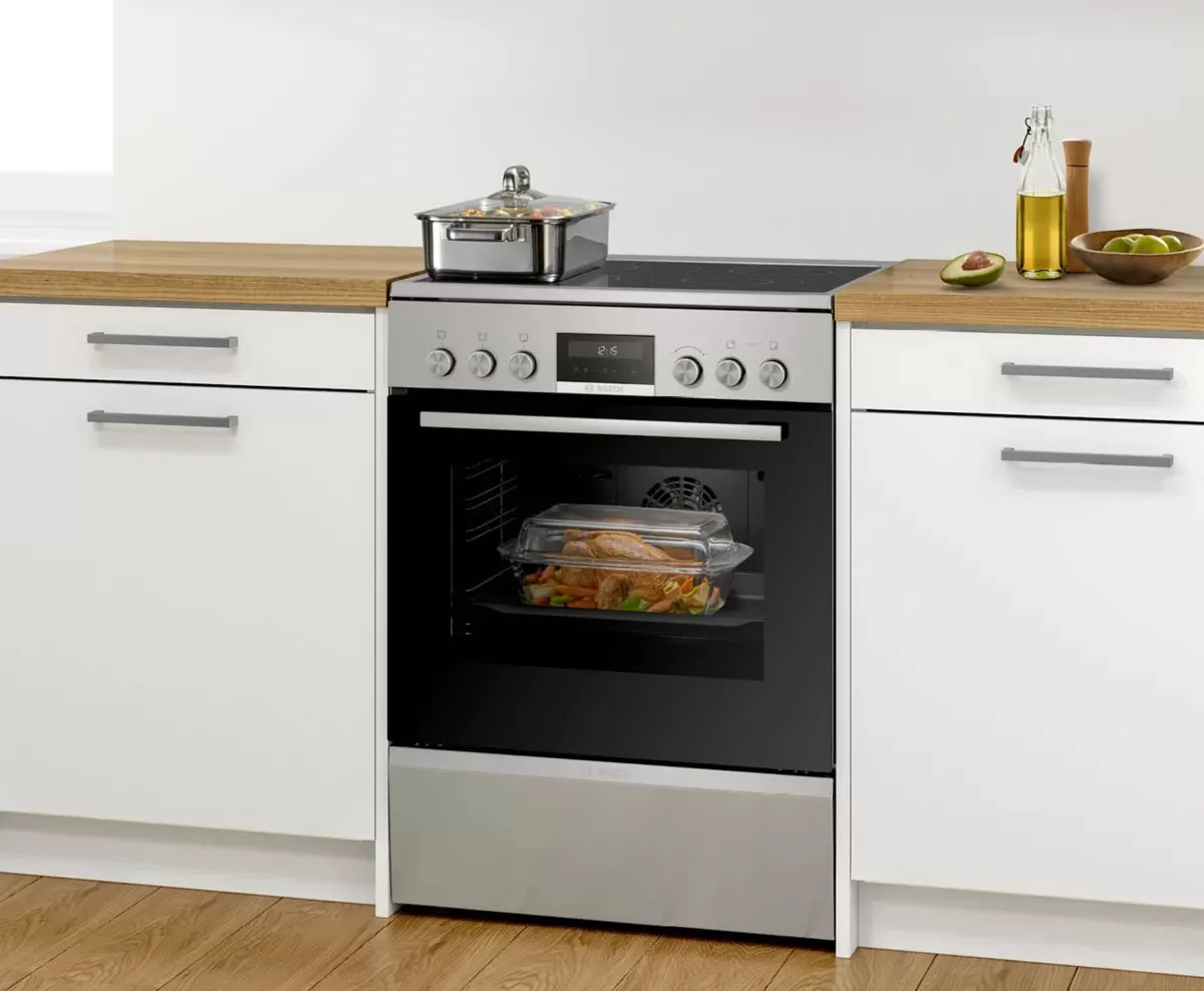 Close-up of Bosch freestanding cooker with digital display and precision knobs, highlighting easy-to-use controls.