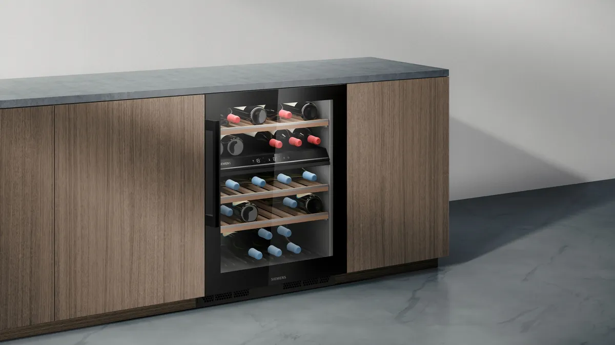 Wooden cabinet with built-in wine cooler, shelves for wine bottles, and closed storage compartments.