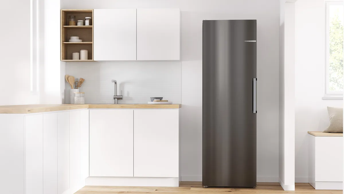 Stainless stelle fridge in a sunny white kitchen.
